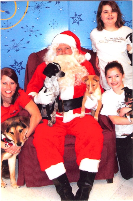Barney on Santa's lap.  Christine and Sophie are in the front row; Nikki is in back.  